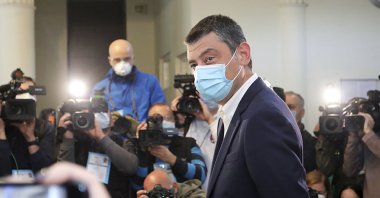 Georgia's Prime Minister Giorgi Gakharia, wearing a mask to help curb the spread of the coronavirus, speaks to the media after voting at a polling station during the parliamentary elections in Tbilisi, Georgia, Oct. 31, 2020. (Georgia's Prime Minister Press office via AP)