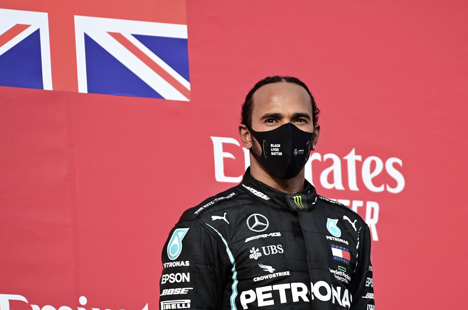 Mercedes driver Lewis Hamilton stands on the podium after winning the F1 Emilia Romagna GP, in Imola, Italy, Nov.1, 2020. (AP Photo)