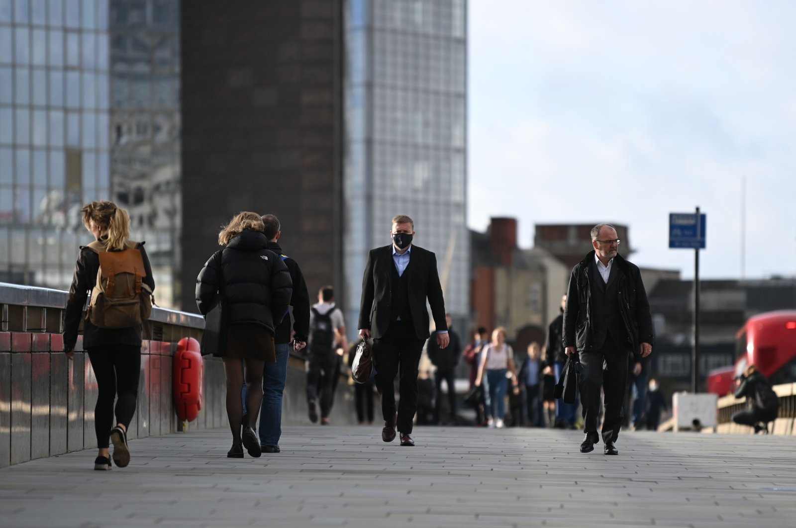 Commuters walk over London Bridge during the morning rush hour in central London, U.K., Nov. 2, 2020. (AFP Photo)