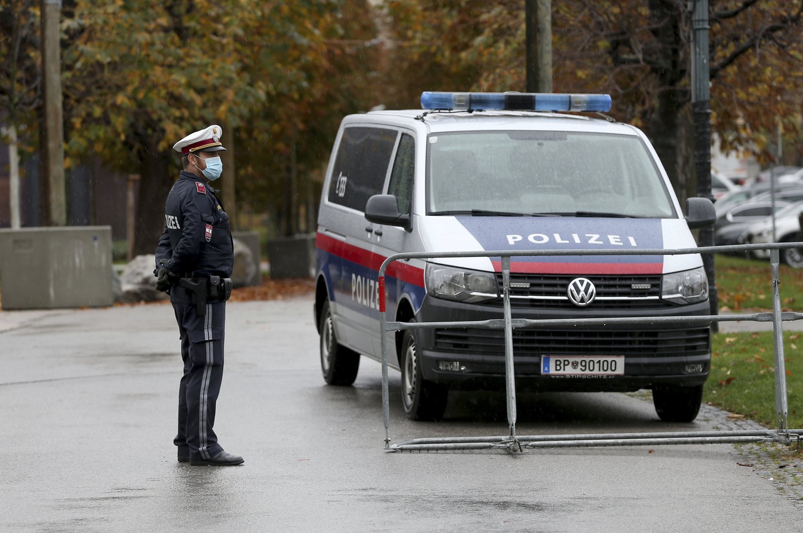 A police officer with a mask standing behind a barrier in downtown Vienna, Austria, Friday, Oct. 30, 2020. (AP File Photo)