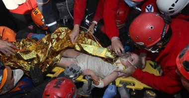 Rescue workers surround Ayda Gezgin, who was pulled from the rubble 91 hours after an earthquake rocked Izmir, western Turkey, Nov. 3, 2020. (AP Photo)