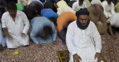 Sunni Muslims living in Greece pray on the first day of Eid al-Fitr (Ramadan Bayram) prayers in Piraeus, near Athens, July. 6, 2016. (AP Photo)
