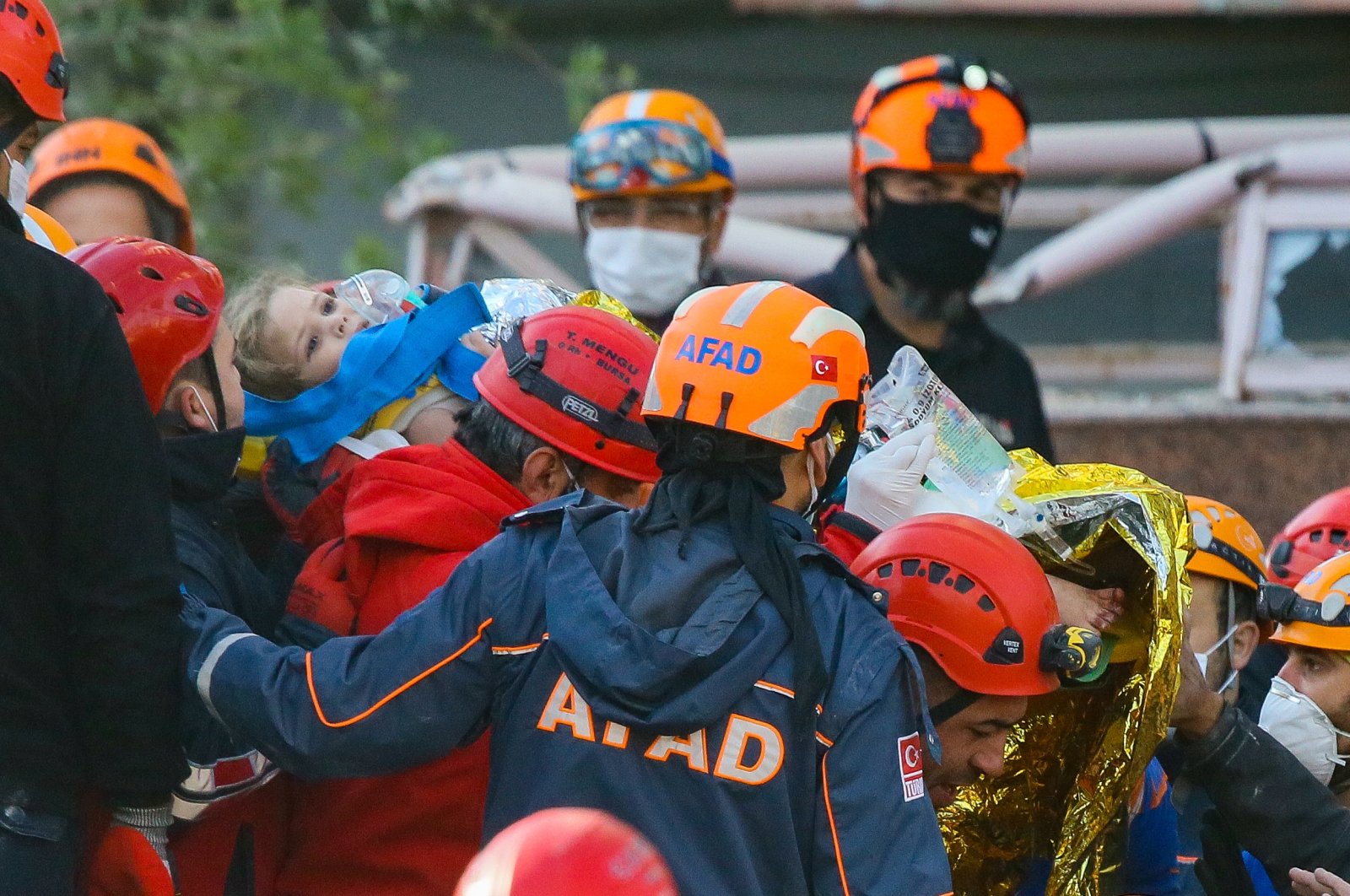 Rescue teams carry 4-year-old Ayda Gezgin after she was rescued from the rubble in the Bayraklı district 91 hours after an earthquake, in Izmir, western Turkey, Nov. 3, 2020. (AA Photo)
