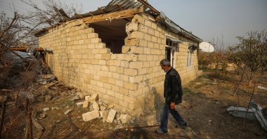 A local resident walks next to his house that was damaged by recent Armenian shelling in the city of Tartar, Azerbaijan, Nov. 2, 2020. (REUTERS Photo)