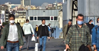 People walk on the Galata Bridge, in Istanbul, Turkey, Nov. 2, 2020. (DHA Photo) 