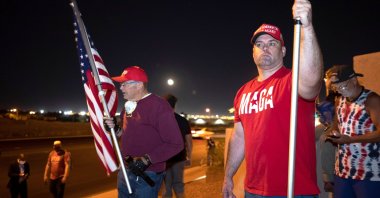 William Carpenter (L) and Lance Baker, supporters of U.S. President Donald Trump, hold American flags during a "Stop the Steal" protest at the Clark County Election Center in North Las Vegas, Nevada, U.S., Nov. 4, 2020. (Reuters Photo)