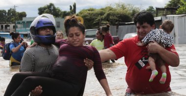 A pregnant woman is carried out of an area flooded by water brought by Hurricane Eta in Planeta, Honduras, Nov. 5, 2020. (AP Photo)