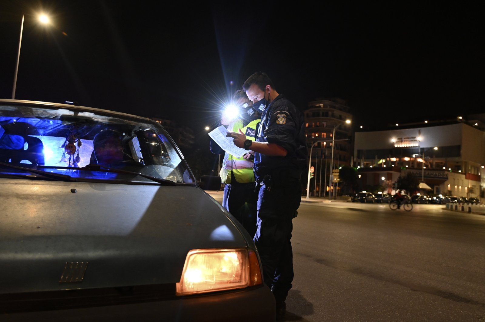 Police check the documents of a driver during the lockdown to contain the spread of COVID-19 in the northern city of Thessaloniki, Greece, Tuesday, Nov. 3, 2020. (AP Photo)