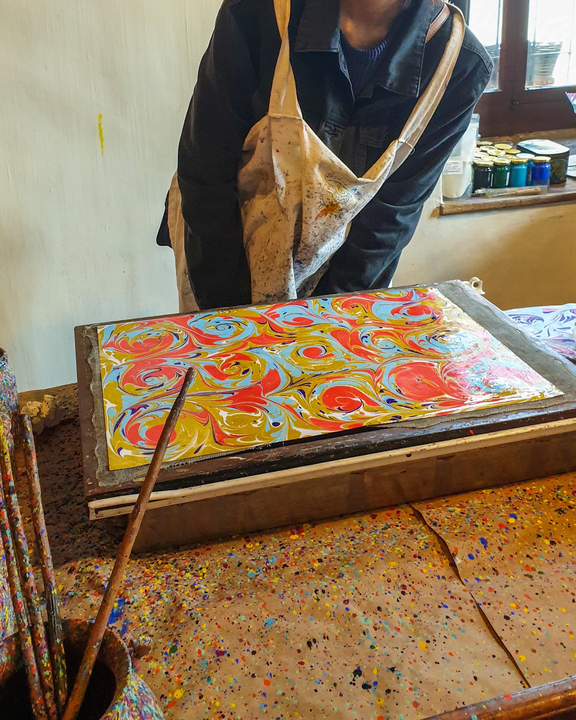 A visitor has a go at making ebru, the traditional Turkish marbling art. (Photo by Argun Konuk)