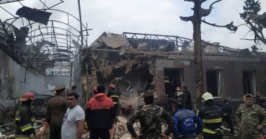 Emergency personnel work in a damaged area of the city of Ganja following a reportedly Armenian rocket strike, during the ongoing fighting between Armenia and Azerbaijan over the occupied Nagorno-Karabakh region, Oct. 4, 2020. (AFP Photo)