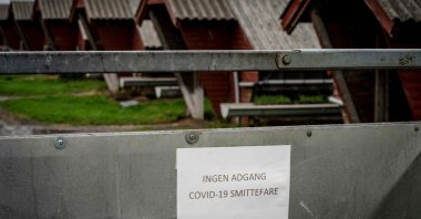 A sign in Danish language reads "No access – risk of Covid-19 infection" at a minks farm in Hjorring, in North Jutland, Denmark, Oct. 8, 2020. (AFP Photo)