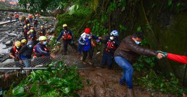 Members of the Red Cross help to evacuate people after the overflow of the Bambito river due to the heavy rains caused by Hurricane Eta, now degraded to a tropical storm, in Bambito, Chiriqui Province, Panama, Nov. 5, 2020. (AFP Photo)