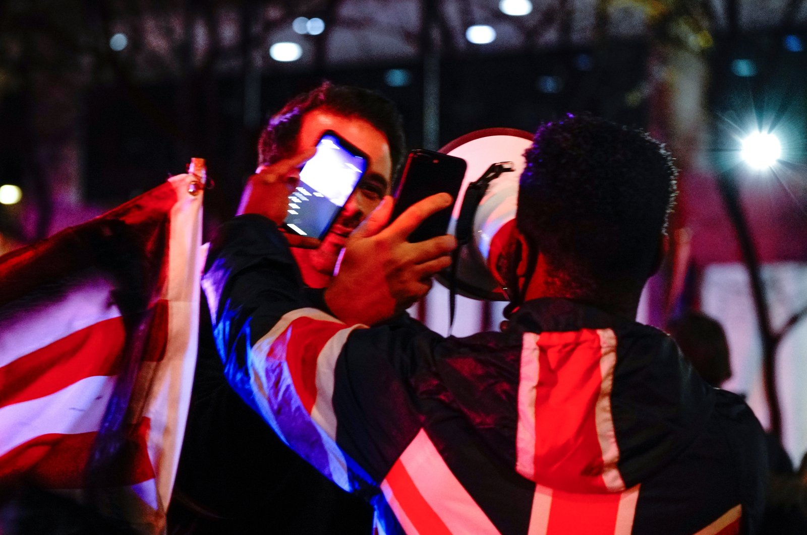 A supporter of U.S. President Donald Trump and a Black Lives Matter (BLM) counterprotester film each other with their mobile phones as they argue at a "Stop the Steal" protest outside Milwaukee Central Count the day after Milwaukee County finished counting absentee ballots, in Milwaukee, Wisconsin, U.S. Nov. 5, 2020. (Reuters Photo)
