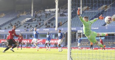Manchester United's Bruno Fernandes, left, scores his side's opening goal during the English Premier League soccer match against Everton at the Goodison Park stadium in Liverpool, England, Nov. 7, 2020. (Carl Recine/Pool via AP)