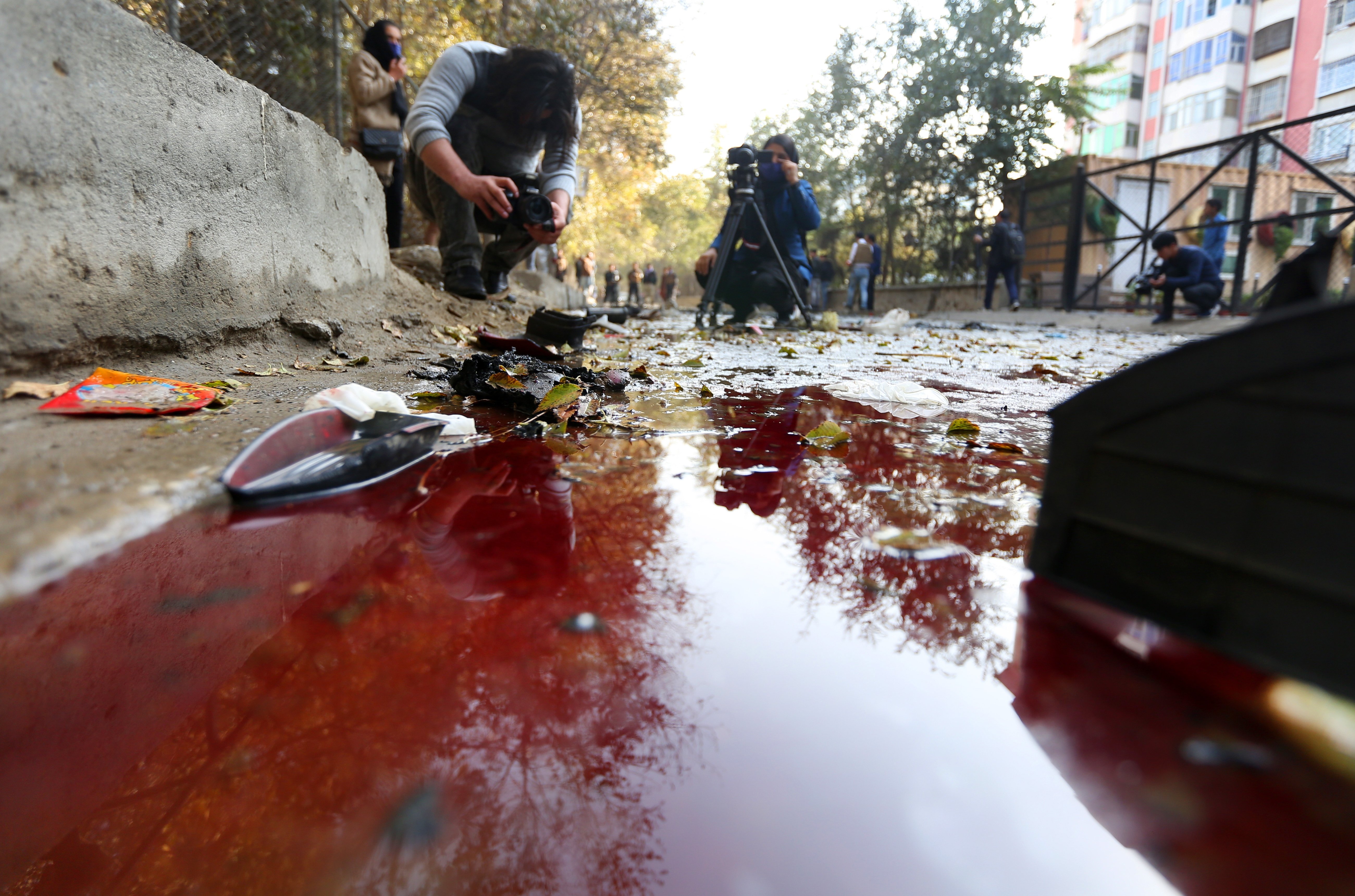 A journalist films blood on the ground at the scene of an explosion. According to local reports, three people, including former Afghan local TV journalist Yama Siawash, were killed in the blast, Kabul, Afghanistan, Nov. 7, 2020. (EPA Photo)