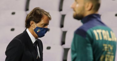 Italy's coach Roberto Mancini wears a face mask during a game against Moldova, in Florence, Italy, Oct. 7, 2020. (AP Photo) 
