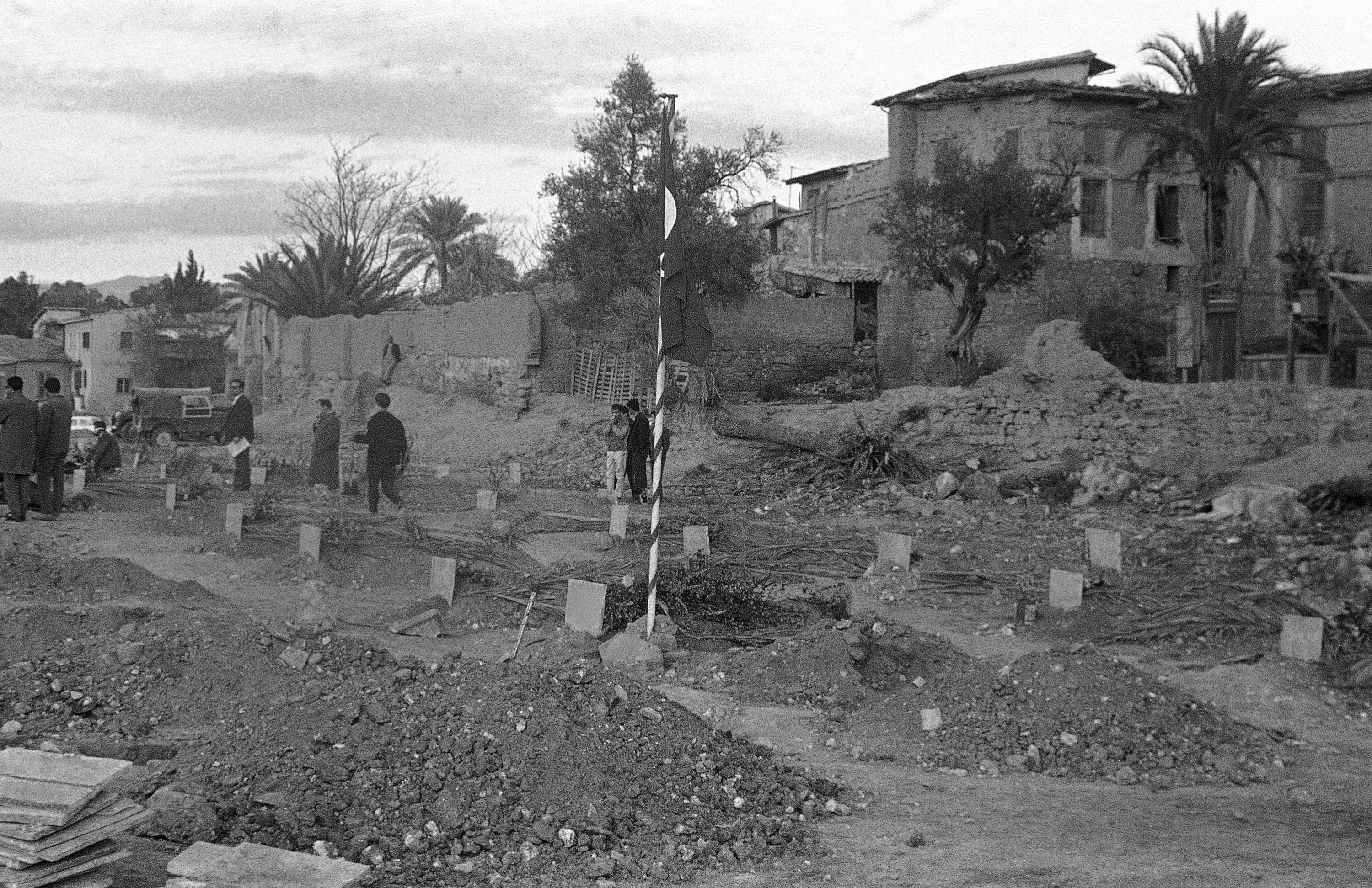 In Turkish Sector, temporary cemetery buried two bodies more which found in Kucuk Kaymakli area on Jan. 7, 1964 in Cyprus and brought here by English Red Cross. Bodies belong to Hodja Huseyin Igneci, 70 and his son Hasan, 16. (AP Photo)