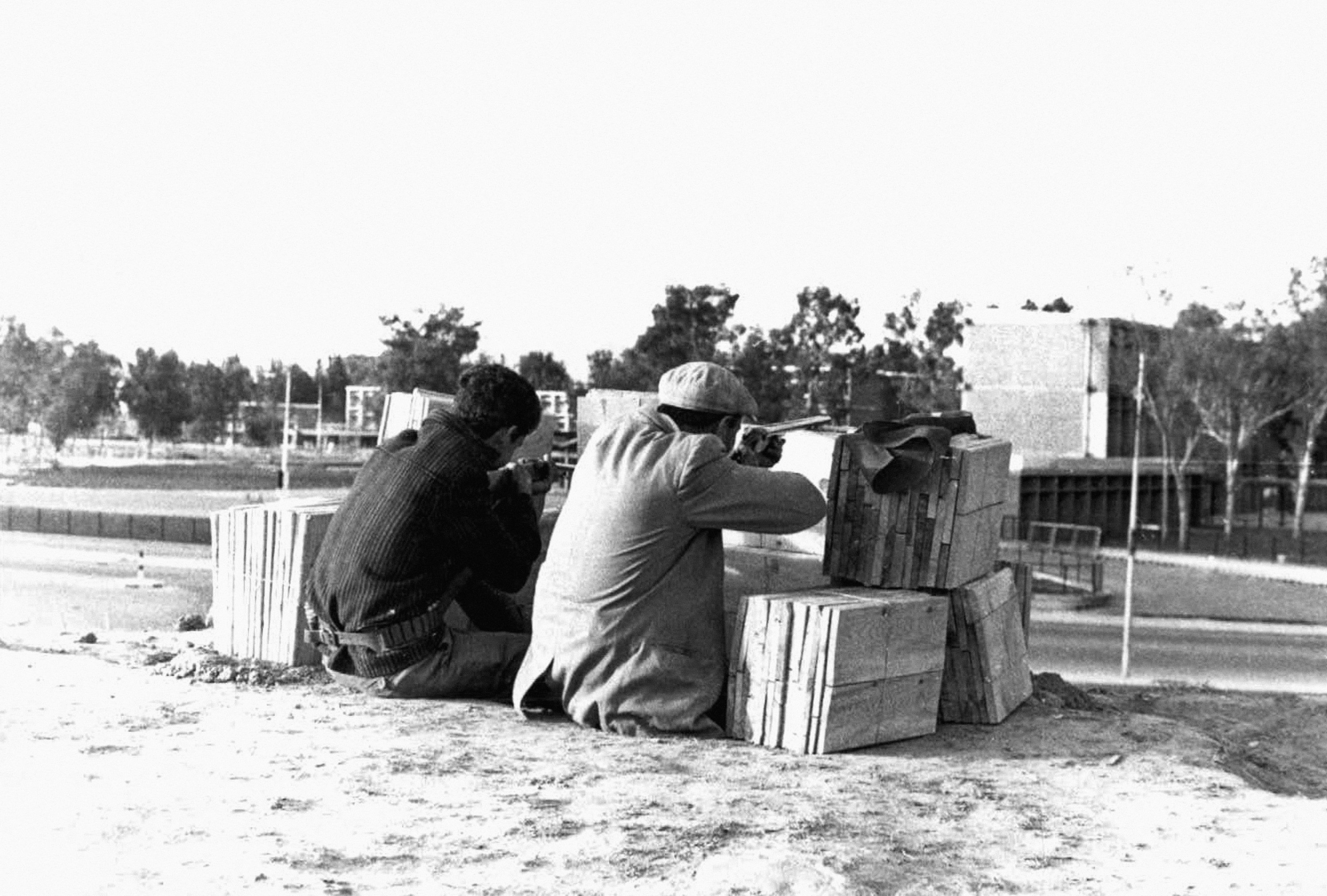 Two Turkish Cypriot civilian ‘Home Guards’ crouch with arms behind a makeshift wooden barricade on the border of the Greek and Turkish sectors of Nicosia on December 27, 1963 after the renewed outbreak of fighting in Cyprus. (AP Photo)