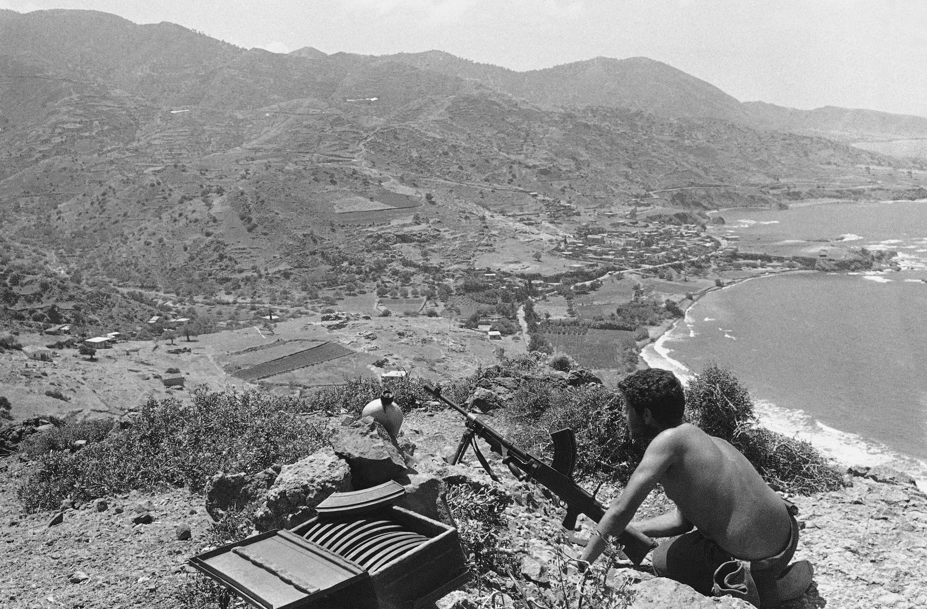 A Turkish Cypriot fighter positions on top the hills outside the village of Kokkina (Erenköy) on Sept. 12, 1964 in Nicosia. The village, housing thousands of refugees starting from 1963, was one of the few areas where arms and supplies could be brought in from Turkey and remained under Greek Cypriot siege for over a decade. (AP Photo)
