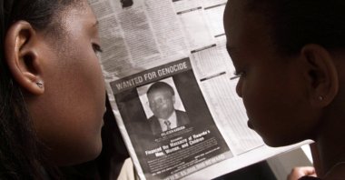 Readers look at a newspaper carrying the photograph of Rwandan Felicien Kabuga wanted by the United States in Nairobi, Kenya, June 12, 2002. (REUTERS Photo)