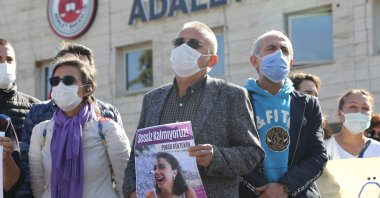 Pınar Gültekin's father Sıddık Gültekin holds her photo outside the courthouse, in Muğla, southwestern Turkey, Nov. 9, 2020. (AA Photo)