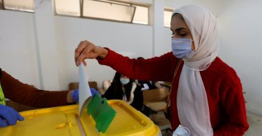 A woman casts her vote during parliamentary elections amid fears over the rising number of coronavirus cases, in Amman, Jordan, Nov. 10, 2020. (Reuters Photo)