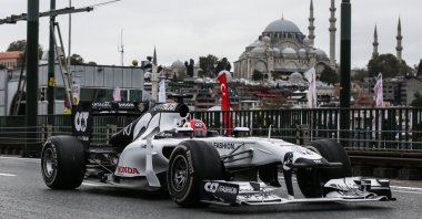 An AlphaTauri Formula One race car crosses Galata Bridge in the historic Eminönü neighborhood of Istanbul, Turkey, Nov. 10, 2020. (AA Photo)
