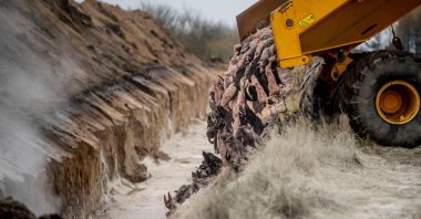 A truck unloads dead mink into a ditch as members of Danish health authorities assisted by members of the Danish armed forces bury the animals in a military area near Holstebro, Denmark, Nov. 9, 2020. (AFP Photo)