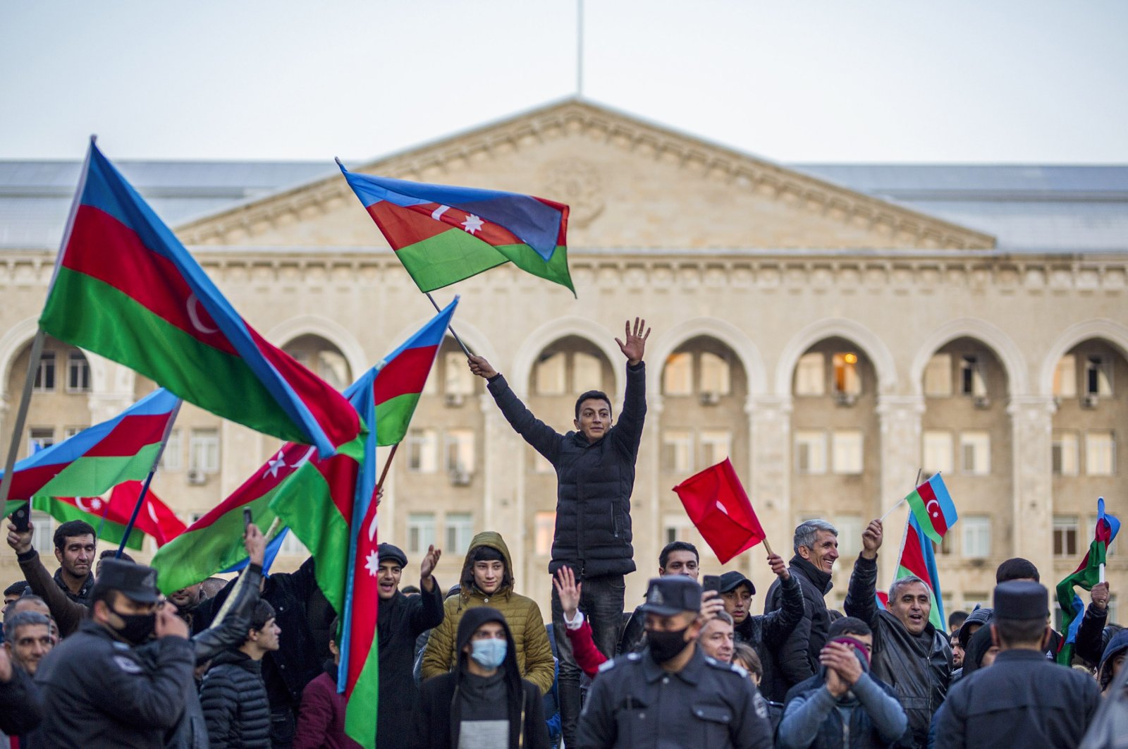 Azerbaijani citizens celebrate the peace deal that is expected to end the 30 yearlong Armenian occupation of Nagorno-Karabakh on Tuesday, Nov. 10, 2020 (AA Photo)