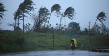 A motorist passes along a street amidst strong winds in Legazpi City, Albay province on November 11, 2020, ahead of the landfall of Tropical Storm Vamco -- expected to intensify into a typhoon -- in the region devastated by two typhoons in less than three weeks. (AFP Photo)