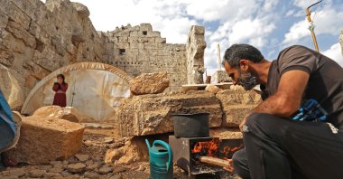 Displaced Syrians are pictured in their makeshift camp amid Roman ruins in the area of Baqirha in northwest Syria not far from the Turkish border on Nov. 1, 2020. (AFP Photo)