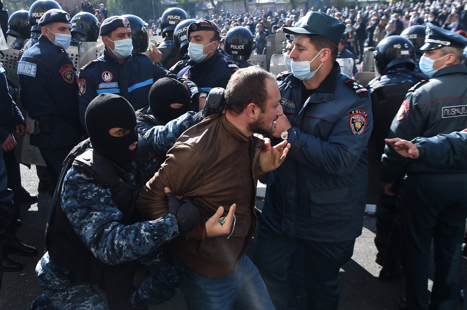 A man is taken away by law enforcement officers during an opposition rally to demand the resignation of Armenian Prime Minister Nikol Pashinyan following the signing of a deal to end the military conflict over the Nagorno-Karabakh region, in Yerevan, Armenia Nov. 11, 2020. (REUTERS)