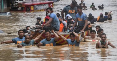 Rescuers pull a rubber boat carrying residents through a flooded street after Typhoon Vamco hit in Marikina City, suburban Manila, Nov. 12, 2020. (AFP Photo)