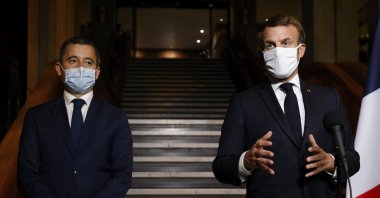 French President Emmanuel Macron (R) delivers a speech while Interior Minister Gerald Darmanin listens nearby, in Bobigny, a northeastern suburb of Paris, France, Oct. 20, 2020. (AP Photo)