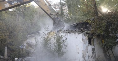 A bulldozer tears down an abandoned house in the capital Ankara, Turkey, Nov. 12, 2020. (AA Photo)