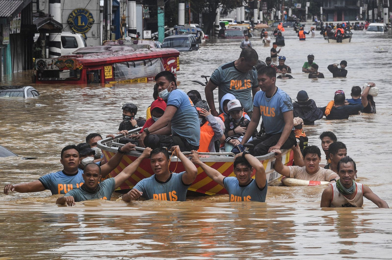 Rescuers pull a rubber boat carrying residents through a flooded street after Typhoon Vamco hit in Marikina City, suburban Manila, Nov. 12, 2020. (AFP Photo)