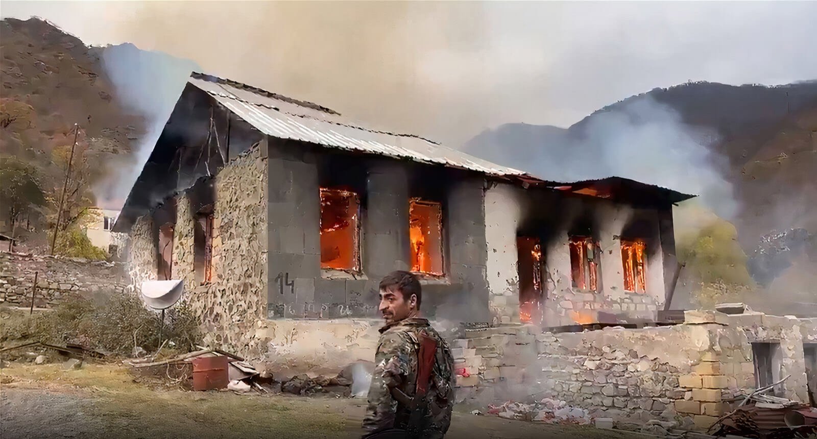 This image grab taken from a video broadcast on Russian media outlets shows a home burnt down by Armenians as they leave it before the arrival of Azerbaijani citizens in the Kalbajar area of Nagorno-Karabakh, Nov. 13, 2020.