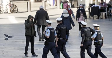 Police officers patrol in a street in Cologne, Germany, where masks are mandatory due to the coronavirus pandemic, Oct. 22, 2020. (AP Photo)
