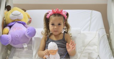 Three-year-old girl Ayda Gezgin sits in her bed in her hospital room after being rescued from the rubble following a 6.6 magnitude earthquake, in Izmir, Turkey, Nov. 5, 2020. (Turkey Health Ministry via AP)