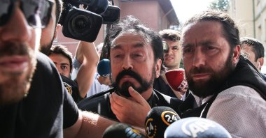 Police escort Adnan Oktar to a hospital for a medical check before his detention, in Istanbul, Turkey, July 12, 2018. (AA Photo)