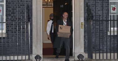 Britain's Prime Minister Boris Johnson's top aide Dominic Cummings leaves 10 Downing Street with a box, in London, Friday, Nov. 13, 2020. (AP Photo)