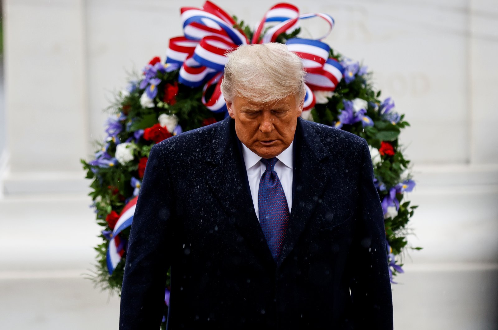 U.S. President Donald Trump turns away in the rain after laying a wreath at the Tomb of the Unknown Soldier in Arlington, Virginia, U.S., on Veteran's Day, Nov. 11, 2020. (Reuters Photo)