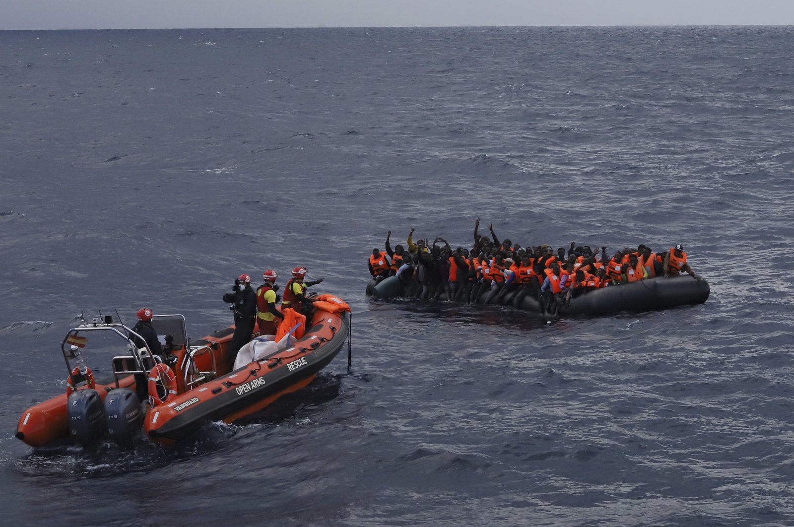 Refugees and migrants wait to be rescued by members of the Spanish NGO Proactiva Open Arms in the Mediterranean Sea, Nov. 11, 2020. (AP Photo)