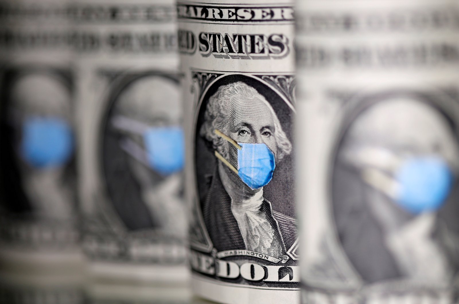 George Washington is seen with a printed medical mask on $1 banknotes in this illustration taken, March 31, 2020. (Reuters Photo)