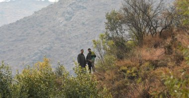Local residents look out from the top of a hill at Kamal Kote village near the Line of Control (LOC), the de facto border between Pakistan and India, at Uri some 135 kilometers (22 miles) east of Srinagar on Nov. 14, 2020. (AFP Photo)