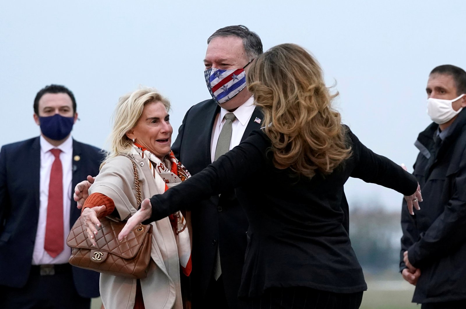 U.S. Secretary of State Mike Pompeo and his wife Susan embrace U.S. Ambassador to France Jamie McCourt after stepping off a plane at Paris-Le Bourget Airport, in Le Bourget, France  Nov. 14, 2020. (REUTERS)
