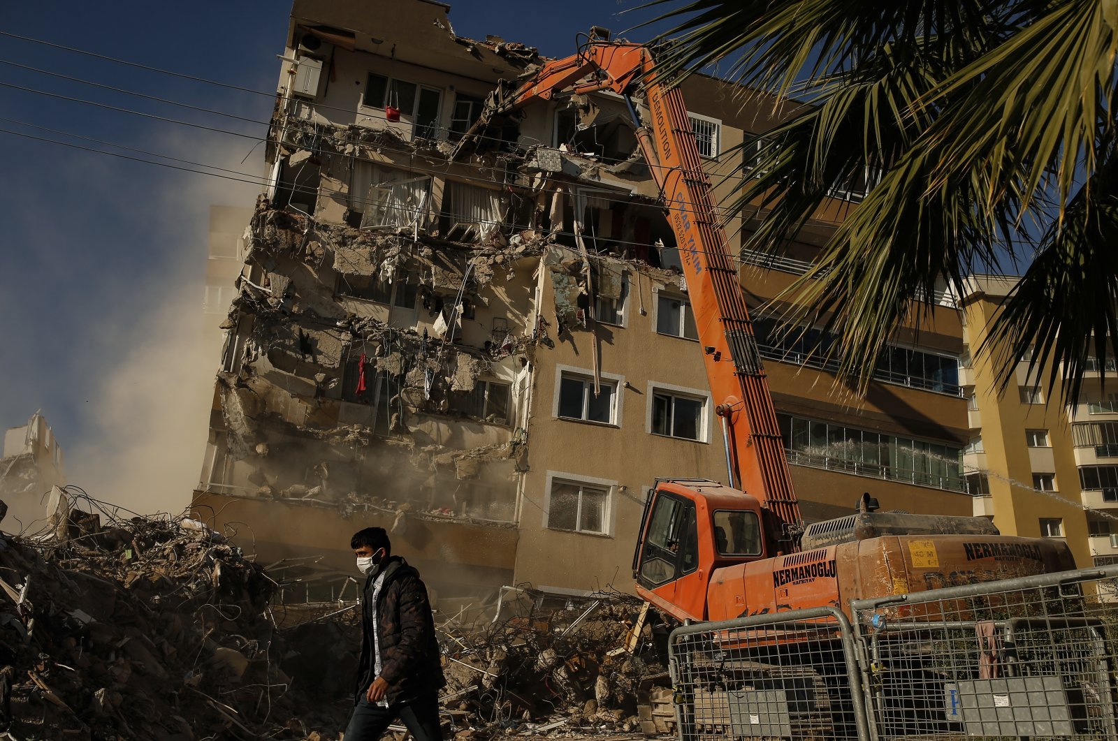 Construction workers demolish a building that was damaged during the Oct. 30 earthquake in Izmir, Turkey, Nov. 4, 2020. (AP Photo)
