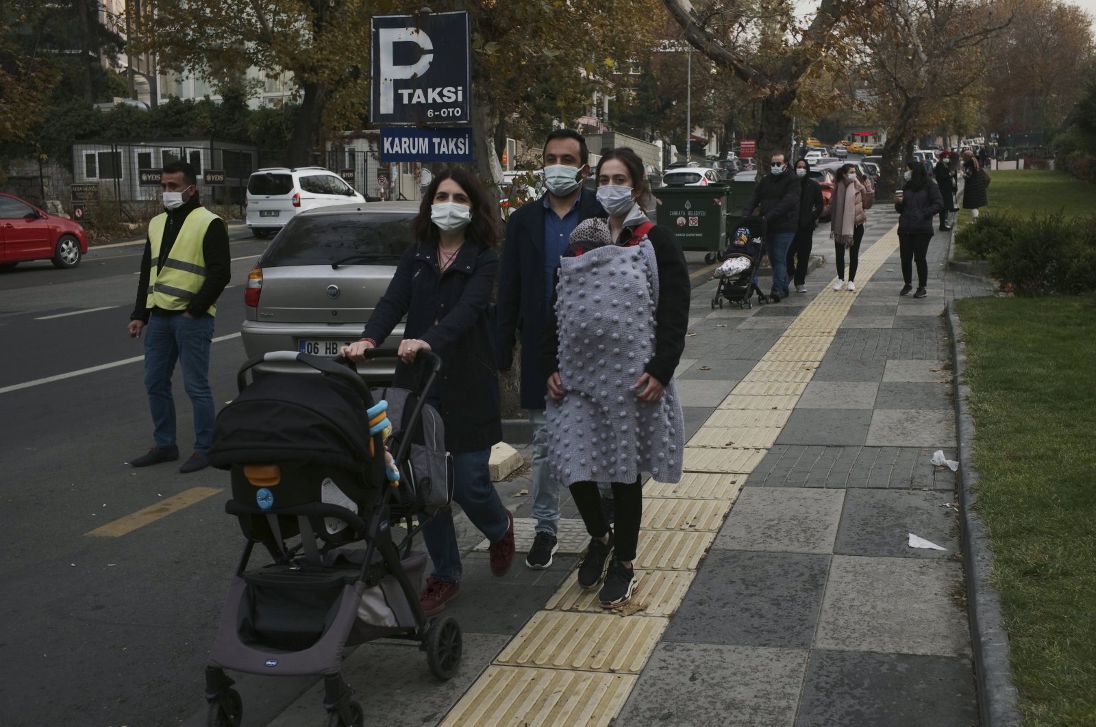 People wearing masks walk on a street in the capital Ankara, Turkey, Nov. 14, 2020. (AP Photo)