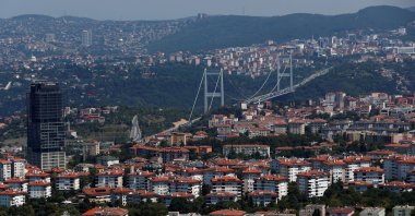 The Fatih Sultan Mehmet Bridge linking the city's European and Asian sides over the Bosporus waterway is seen behind residential apartment blocks in Istanbul, Turkey, Aug. 1, 2019. (Reuters Photo)