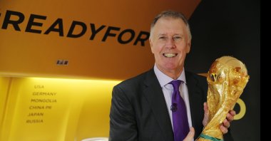 Geoff Hurst holds the FIFA World Cup trophy during the first leg of the soccer World Cup 2018 trophy tour at Stansted Airport, London, England, Jan. 22, 2018. (AP Photo)